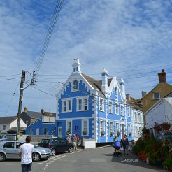 Blue building and cloudy sky at The Lizard, Cornwall.